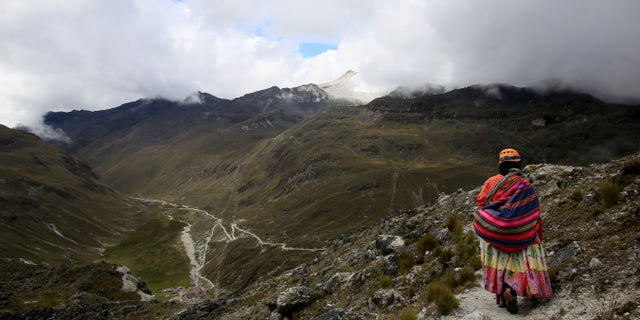 An Aymara indigenous woman walks on the Huayna Potosi mountain, Bolivia April 6, 2016.