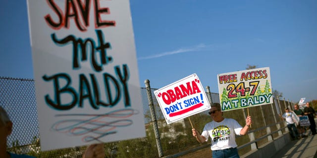 Oct. 10, 2014: Protesters hold signs to oppose President Barack Obama's designation of the San Gabriel Mountains as a national monument before Obama's visit to Frank G. Bonelli Regional Park in San Dimas, Calif.