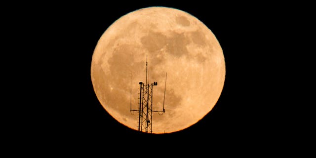 The moon rises over a building in Netanya, Israel, Sunday, Dec. 3, 2017. The Dec. 3 full moon is the first of three consecutive supermoons. The other two will occur on Jan. 1 and Jan. 31, 2018. (AP Photo/Ariel Schalit)