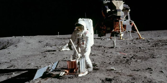 Buzz Aldrin deploys a seismometer in the Sea of Tranquillity area of the moon.