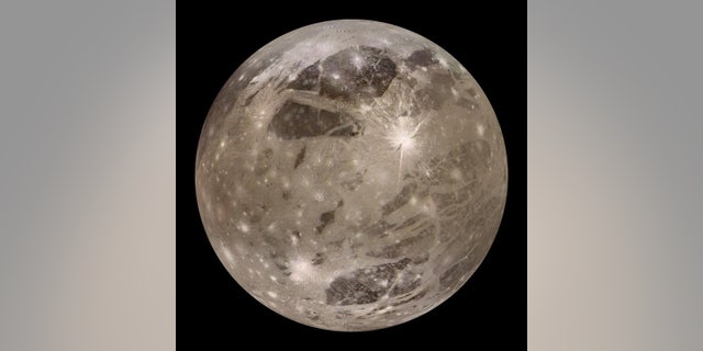 One of Jupiter's moons, Ganymede, is seen above.