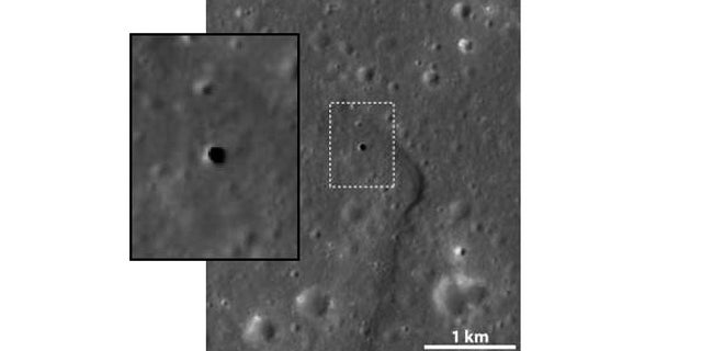 This apparent hole in the moon is like a skylight, a vertical cave 213 feet across and some 262 to 289 feet deep. It is thought to be a collapsed lava tube. The inset shows close-up of the boxed area.