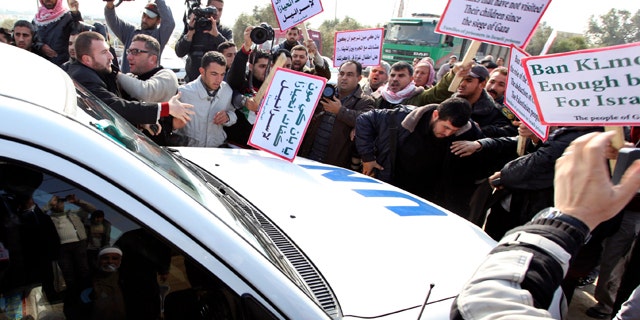 Feb. 2: Palestinian protesters surround a vehicle in the convoy of U.N. Secretary-General Ban Ki-moon as it arrives at Erez border crossing between Israel and Gaza.