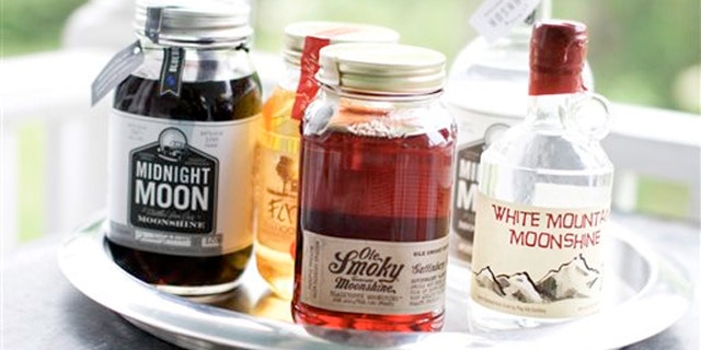 June 10, 2013: Midnight Moon Blueberry, FireFly Moonshine Apple Pie Flavor, Ole Smoky Tennessee Moonshine Blackberry, Midnight Moon Moonshine, and White Mountain Moonshine are shown in Concord, N.H.