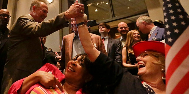 Former Alabama Chief Justice and U.S. Senate candidate Roy Moore, greets supporter Patricia Jones, right, before his election party, Tuesday, Sept. 26, 2017, in Montgomery, Ala.