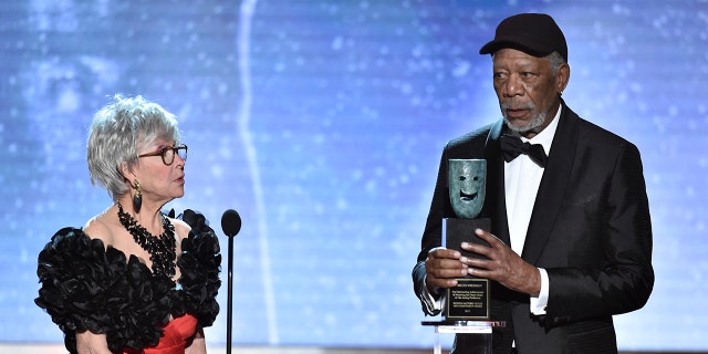 Rita Moreno, left, looks on as Morgan Freeman accepts the Life Achievement Award at the 24th annual Screen Actors Guild Awards at the Shrine Auditorium & Expo Hall on Sunday, Jan. 21, 2018, in Los Angeles. (Photo by Vince Bucci/Invision/AP)