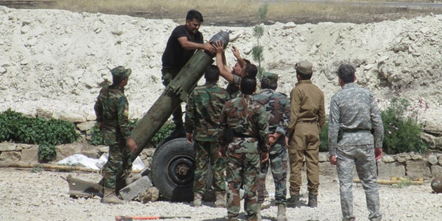 When it was ready to fire, the Peshmerga fighters crouched behind sandbags in case the mortar blew up.