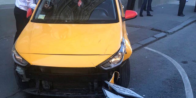 This image provided by Moscow Traffic Control Center Press Service, shows a taxi after crashing into pedestrians on a sidewalk near Red Square in Moscow