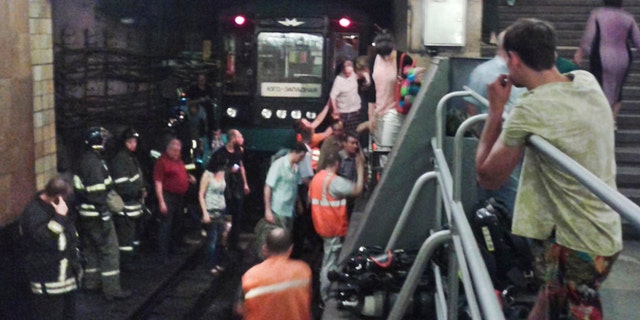June 5, 2013: In this image made by a mobile phone camera, people leave a subway station in downtown Moscow.. A rush-hour fire in Moscows subway injured dozens of people, forced the evacuation of thousands of commuters and closed parts of the network on Wednesday, authorities said.