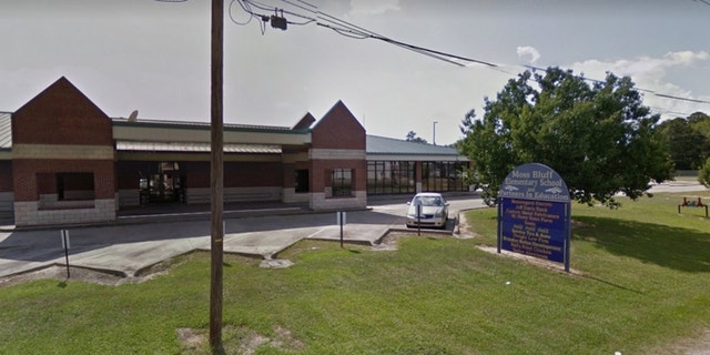 A gun dropped out of a student's backpack in Moss Bluff Elementary School on Monday, accidentally discharging and striking another boy in the classroom.
