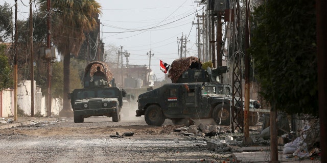 Iraqi security forces advance during fighting against Islamic State militants, in western Mosul, Iraq, Wednesday, March 1, 2017.