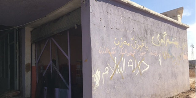 Homes that ISIS fighters occupied until just weeks ago are strewn with trash and emblazoned with graffiti.