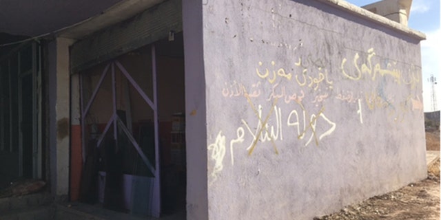 Homes that ISIS fighters occupied until just weeks ago are strewn with trash and emblazoned with graffiti.