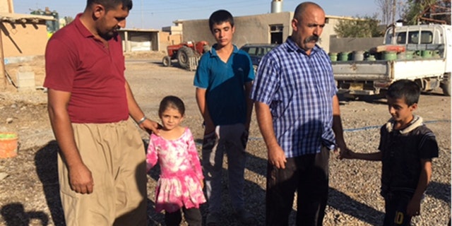 Falah and his eldest daughter, his brother Ahmed with his two sons.