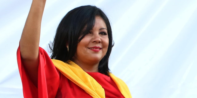 In this Friday, Jan. 1, 2016 photo, Gisela Mota waves during her swearing in ceremony as mayor of Temixco, Morelos State, Mexico. The Morelos state Public Security Commission says attackers invaded Mota's house on Saturday morning and killed her. (AP Photo/Tony Rivera)
