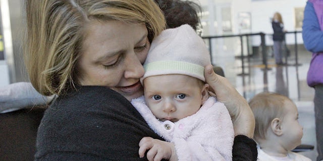 Lissa Pierce Bonifaz , left, of Boston, holds her 11-week-old baby, Marisol,  during a breast-feeding rally near the Delta Airlines ticket counter at Logan International Airport in Boston, Tuesday, Nov. 21, 2006, as Alison Yaker, of Somerville, Mass., holds her 6 month-old son, Charlie. At center is Ruth Leib, 8 month-old, who attended the rally with her mother Joan, not seen.  Mothers were there to protest the removal of a nursing mother from a Delta Airlines commuter flight in Burlington, Vt. (AP Photo/Chitose Suzuki)