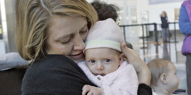 Lissa Pierce Bonifaz , left, of Boston, holds her 11-week-old baby, Marisol, during a breast-feeding rally near the Delta Airlines ticket counter at Logan International Airport in Boston, Tuesday, Nov. 21, 2006, as Alison Yaker, of Somerville, Mass., holds her 6 month-old son, Charlie. At center is Ruth Leib, 8 month-old, who attended the rally with her mother Joan, not seen. Mothers were there to protest the removal of a nursing mother from a Delta Airlines commuter flight in Burlington, Vt. (AP Photo/Chitose Suzuki)