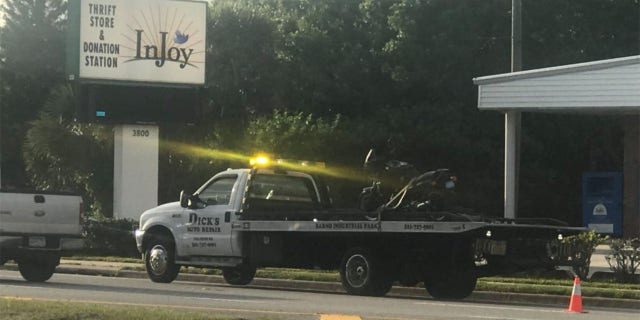 Alexander's motorcycle is loaded onto a truck following the accident.