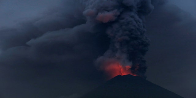 Glowing light of hot lava is seen during the eruption of Mount Agung as seen from Amed in Karangasem, Bali, Indonesia, November 27, 2017. (REUTERS/Johannes P. Christo)