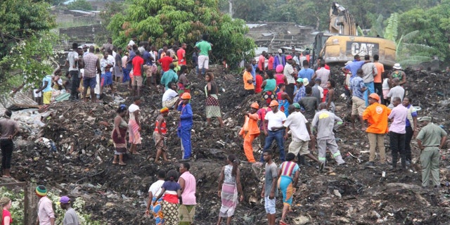 Rescuers search for survivors at the collapse of a garbage mound in Maputo, Mozambique.