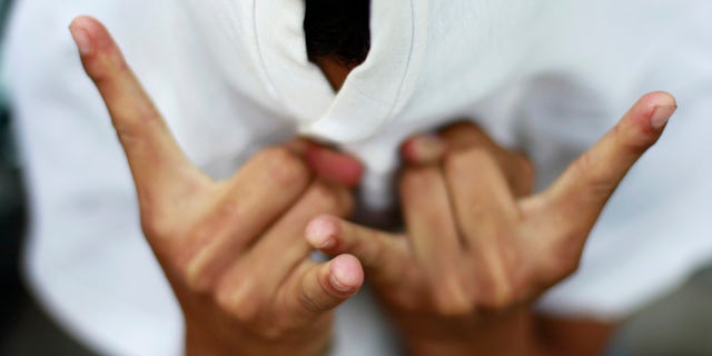 A member of the MS-13 street gang gestures during an event in San Vicente, El Salvador.