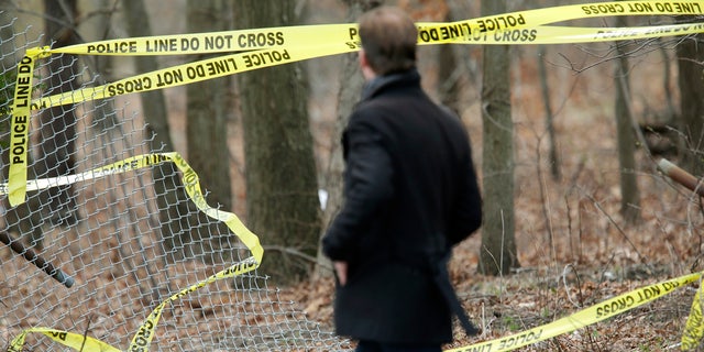 Police tape is seen in a wooded area of Long Island, New York, where remains were discovered. It is believed that the victims were killed by MS-13 gang members.