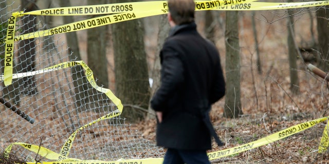 Police tape is seen in a wooded area of Long Island, New York, where remains were discovered. It is believed that the victims were killed by MS-13 gang members.