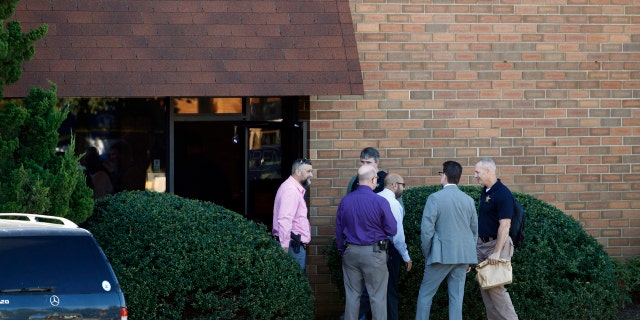Officials stand outside the scene of a fatal shooting at a business park in the Edgewood area of Harford County, Md., Wednesday, Oct. 18, 2017.