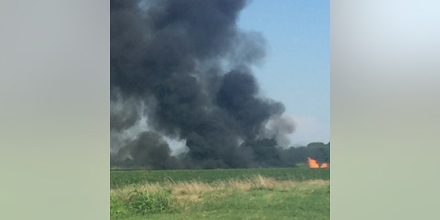 Smoke rises from the site where a Marine KC-130 refueling plane crashed in Leflore County, Miss., Monday evening.