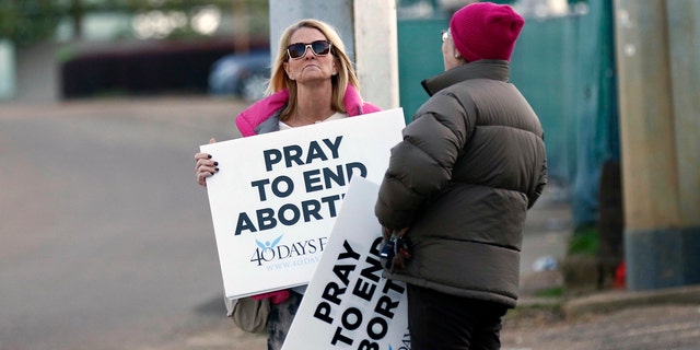 Pro-life activists stand outside the Jackson Women's Health Organization, Mississippi's only abortion clinic.