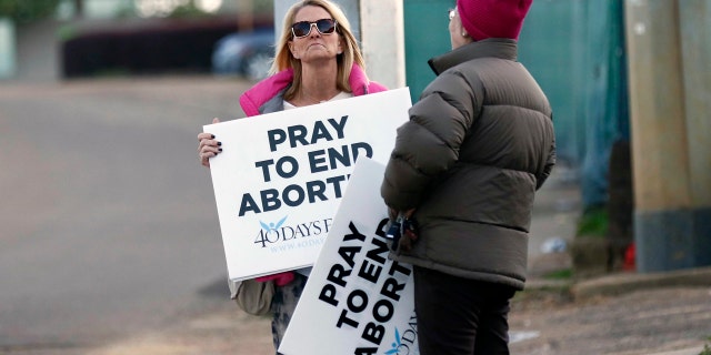 Pro-life activists stand outside the Jackson Women's Health Organization, Mississippi's only abortion clinic.