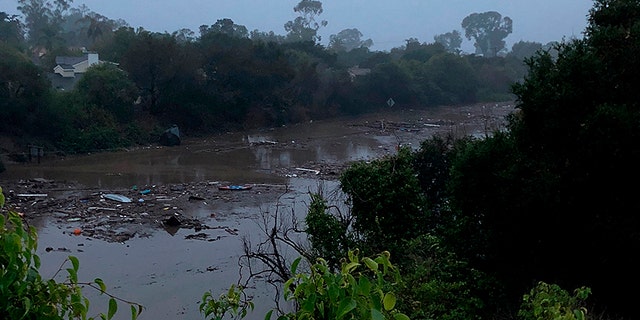 Flood waters and debris from a mud slide cover the 101 Freeway in Santa Barbara, Calif. outside the Montecito Inn.