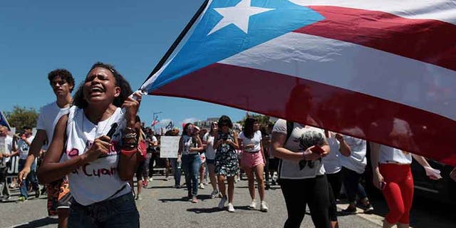 Students of the University of Puerto Rico protest as a meeting of the Financial Oversight and Management Board for Puerto Rico is taking place at the Convention Center in San Juan, Puerto Rico March 31, 2017. Picture taken March 31, 2017. REUTERS/Alvin Baez - RTX356BB