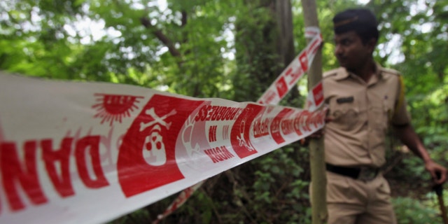 Aug. 23, 2013: An Indian policeman inspects the site where a 22-year-old woman was gang raped in Mahalaxmi area in Mumbai India.