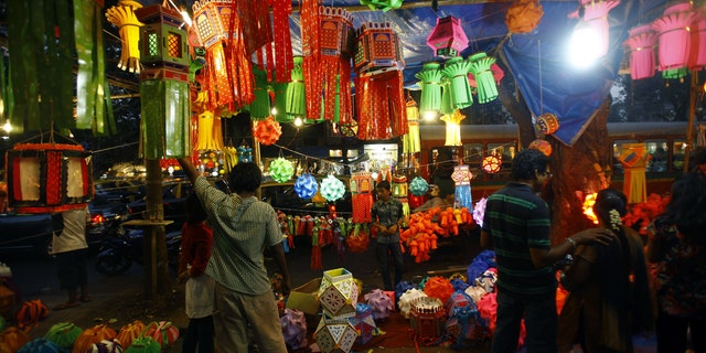 Indians buy lanterns from roadside stalls ahead of the Hindu festival of lights, Diwali, in Mumbai, India, Sunday, Nov. 11, 2012. People decorate their homes during this festival. (AP Photo/Rafiq Maqbool)