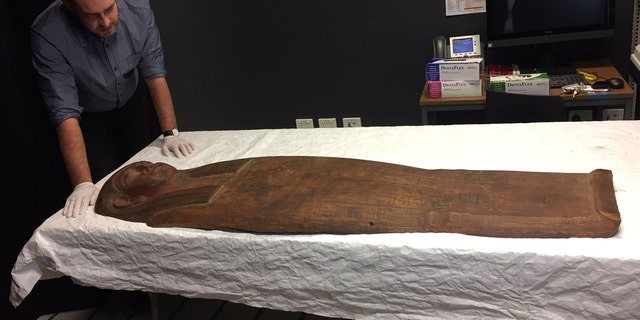 A 2,500-year old coffin that may contain a mummy lies at the University of Sydney in Sydney, Australia March 27, 2018. (REUTERS/Colin Packham)