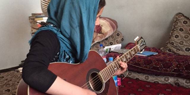 Mursal playing guitar