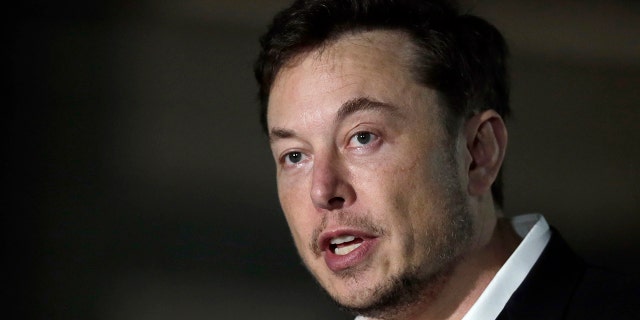 FILE - In this Thursday, June 14, 2018 file photo, Tesla CEO and founder of the Boring Company Elon Musk speaks at a news conference, in Chicago. On Tuesday, July 19, 2018, The Associated Press has found that stories circulating on the internet that Musk announced plans to leave Tesla to start a digital currency company are untrue. (AP Photo/Kiichiro Sato, File)