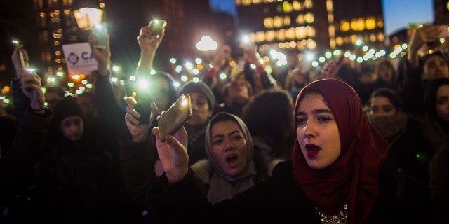 Muslim women shout slogans during a rally against President Donald Trump's order cracking down on immigrants living in the U.S. at Washington Square Park in New York, Wednesday, Jan. 25, 2017. (AP Photo/Andres Kudacki)