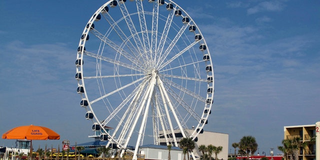 The 200-foot-tall SkyWheel is seen from the shore in Myrtle Beach, S.C., shortly before opening on Friday, May 20, 2011. The SkyWheel, the tallest Ferris wheel in the eastern United States with a million LED lights and 42 air-conditioned gondolas, started spinning Friday in this beach resort on the South Carolina coast. (AP Photo/Bruce Smith)