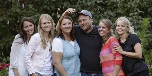 Sept. 11, 2013. Brady Williams poses with his wives, from left to right, Paulie, Robyn, Rosemary, Nonie, and Rhonda, outside of their home in a polygamous community outside Salt Lake City.