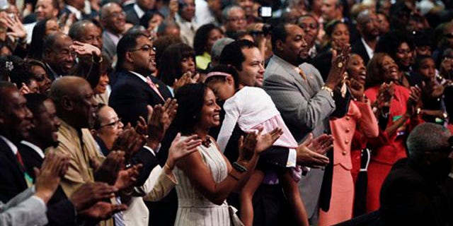 The audience applauds after first lady Michelle Obama speaks at the annual NAACP convention July 12 in Kansas City, Mo. (AP Photo)