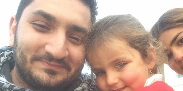 Nabil, shown here at an Iraqi refugee camp with a displaced child, has seen terror attacks first-hand before.
