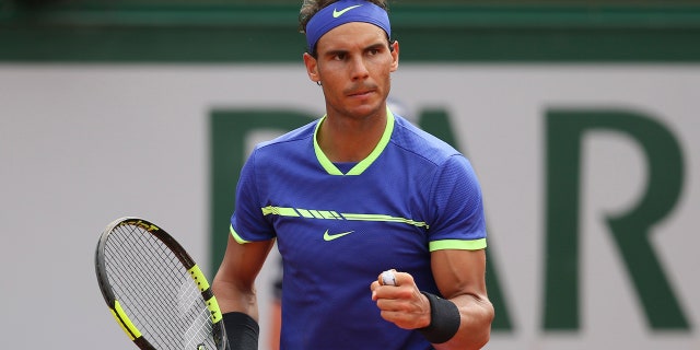 Spain's Rafael Nadal clenches his fist as he plays Switzerland's Stan Wawrinka during their final match of the French Open tennis tournament at the Roland Garros stadium, Sunday, June 11, 2017 in Paris.