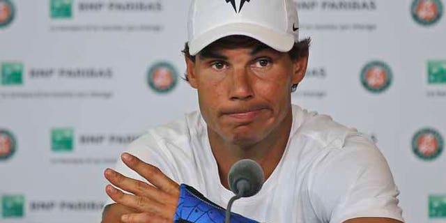 Nine-time champion Rafael Nadal announces he is pulling out of the French Open because of an injury to his left wrist during a press conference at the Roland Garros stadium in Paris, France, Friday May 27, 2016. The left-handed Nadal made the announcement at a hastily arranged news conference Friday, one day before he would have been scheduled to play his third-round match. (AP Photo/Michel Euler)