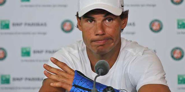 Nine-time champion Rafael Nadal announces he is pulling out of the French Open because of an injury to his left wrist during a press conference at the Roland Garros stadium in Paris, France, Friday May 27, 2016. The left-handed Nadal made the announcement at a hastily arranged news conference Friday, one day before he would have been scheduled to play his third-round match. (AP Photo/Michel Euler)
