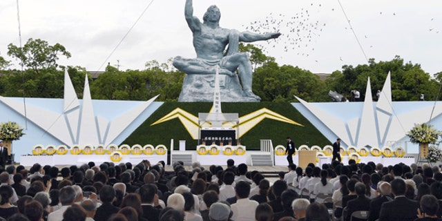 Doves fly over the Statue of Peace at Nagasaki Peace Park in Nagasaki, southern Japan, during a ceremony to mark the 72nd anniversary of the world's second atomic bomb attack, Aug. 9, 2017.