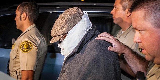 Nakoula, seen here in 2013 being escorted out of his home in Cerritos, Calif., lives under constant threat.