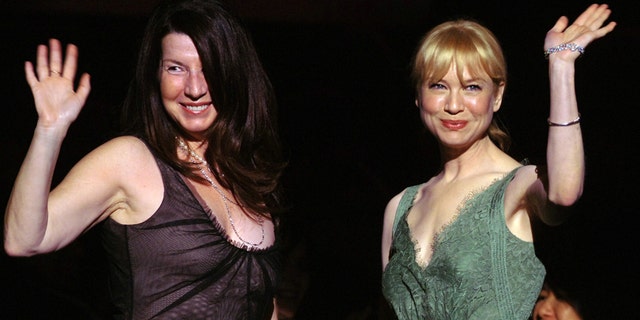 Actress Rene Zellweger, right, and publicist Nanci Ryder wave after they are acknowledged by the audience at the start of "What A Pair! 3," a concert of songs from Broadway musicals performed by duets of famous women, to benefit the Friends of the Breast Program at the University of California in Los Angles (UCLA) April 8, 2005.