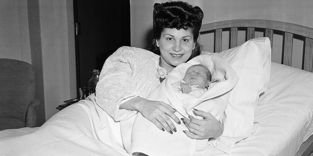 In this Jan. 10, 1944 file photo, Nancy Sinatra holds her newborn son, Frank, at Margaret Hague Maternity Hospital in Jersey City, N.J.